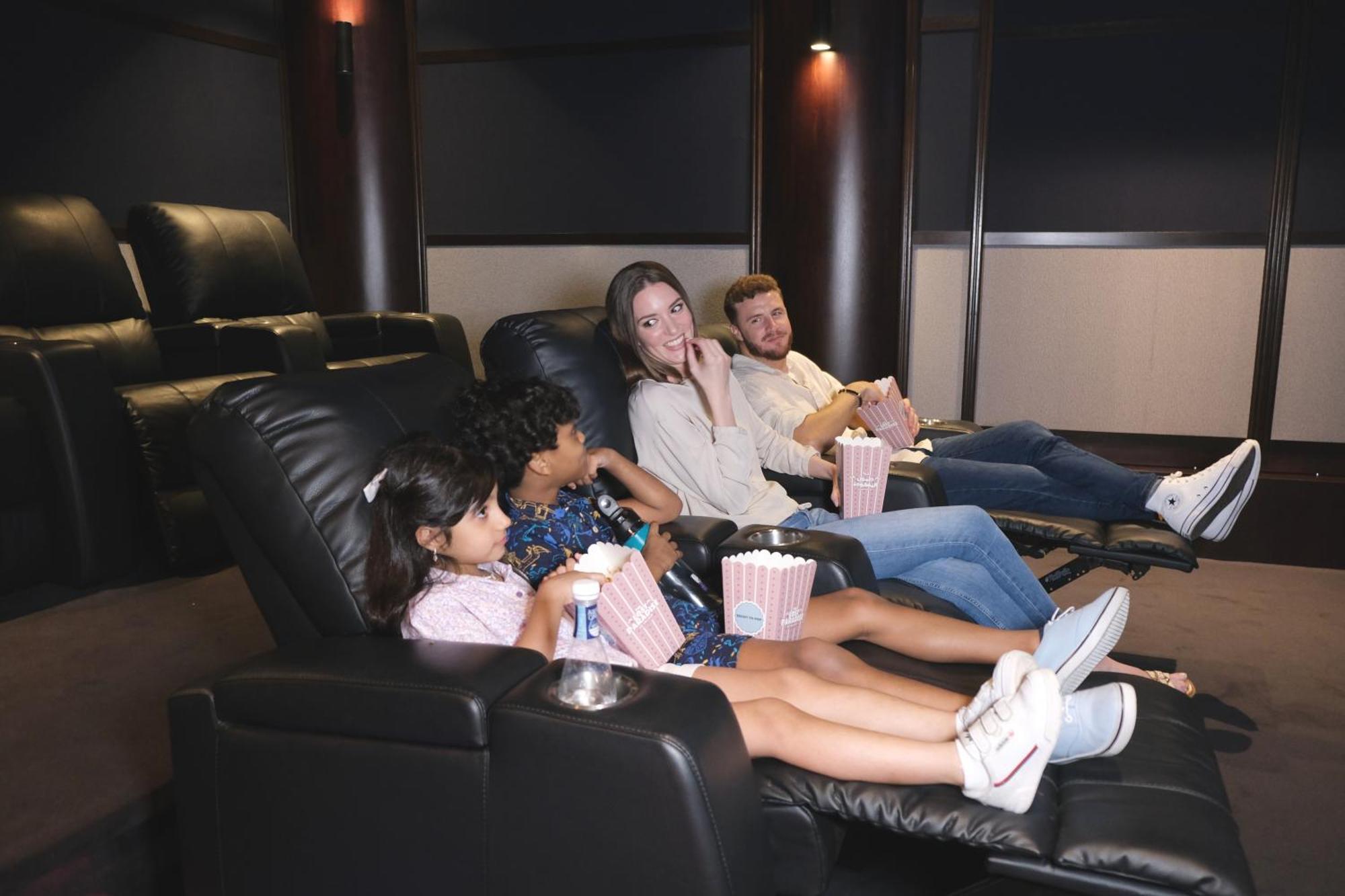 Hotel Charthouse Bahrain Manama Zewnętrze zdjęcie A family watching a movie in a home theater
